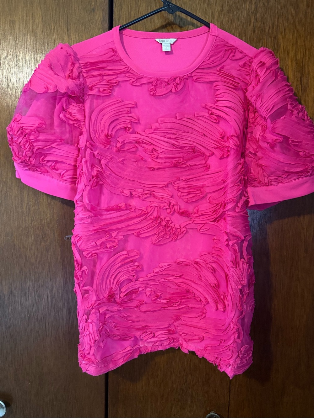 Hot pink blouse from Cato featuring 3d textured swirls and puffed sleeves